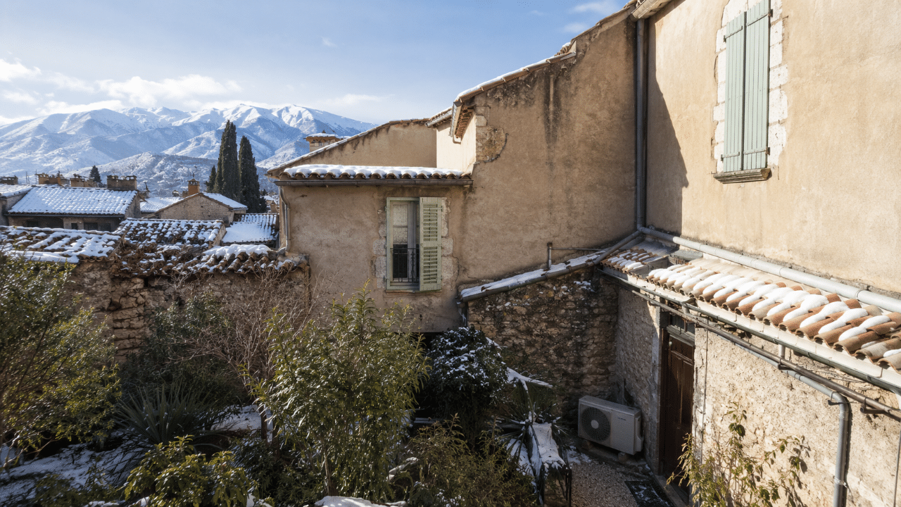 Climatiseur réversible en cour d'une maison ancienne de Prades